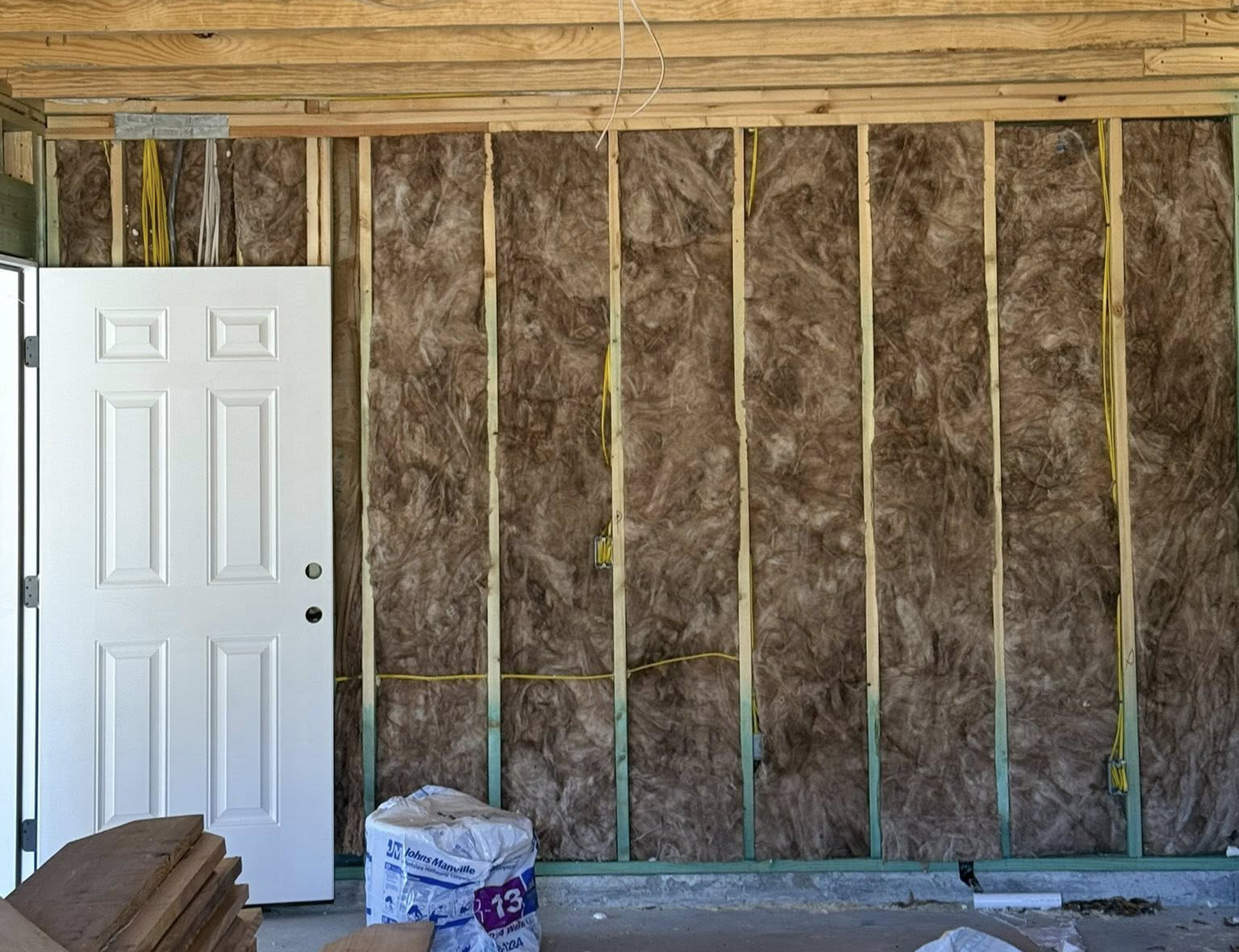 Fiberglass bat insulation around doorframe